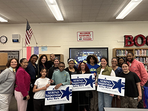 Couny Executive, middle school staff and honorees taking picture with Superstars sign