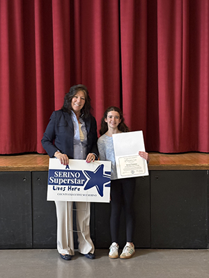 County Executive Sue Serino taking picture with honoree holding certificate and yard sign