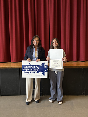 County Executive Sue Serino taking picture with honoree holding certificate and yard sign