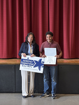 County Executive Sue Serino taking picture with honoree holding certificate and yard sign