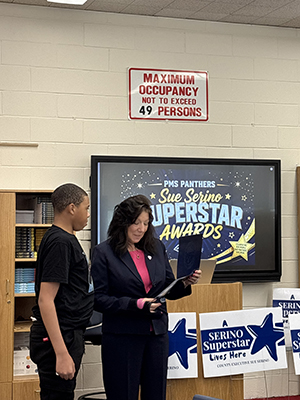 County Executive reading certificate to student