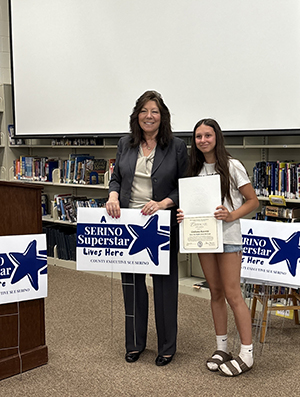 County Executive Sue Serino and taking picture with honoree with their certificate and yard sign