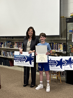County Executive Sue Serino and taking picture with honoree with their certificate and yard sign