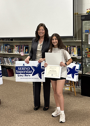 County Executive Sue Serino and taking picture with honoree with their certificate and yard sign