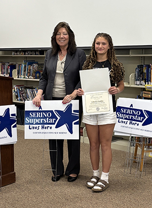 County Executive Sue Serino and taking picture with honoree with their certificate and yard sign
