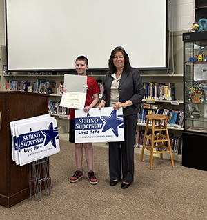 County Executive Sue Serino and taking picture with honoree with their certificate and yard sign