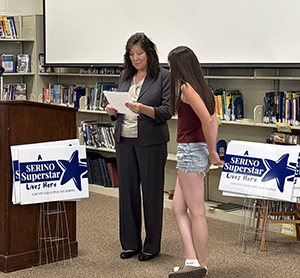 County Executive Sue Serino reading to student why they were nominated 