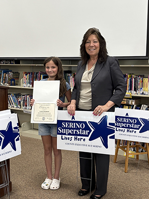 County Executive Sue Serino and taking picture with honoree with their certificate and yard sign