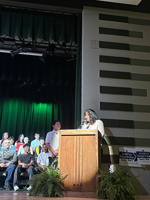 Sue Serino presenting certificate to student