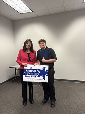 County Executive Sue Serino taking picture with honoree with their certificate and yard sign