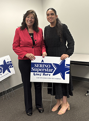 County Executive Sue Serino taking picture with honoree with their certificate and yard sign