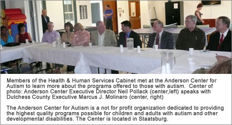 County Executive Molinaro sitting with County employees and representatives from Anderson Center for Autism