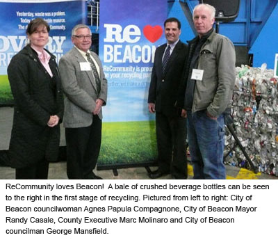 County Executive Molinaro standing next to crushed bottles with Mayor Casale and members from Beacon Council