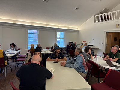 People having a discussion at a long table