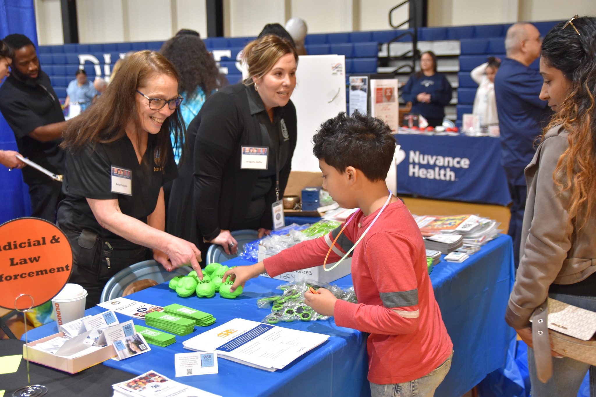 child talking with vendor at health fair